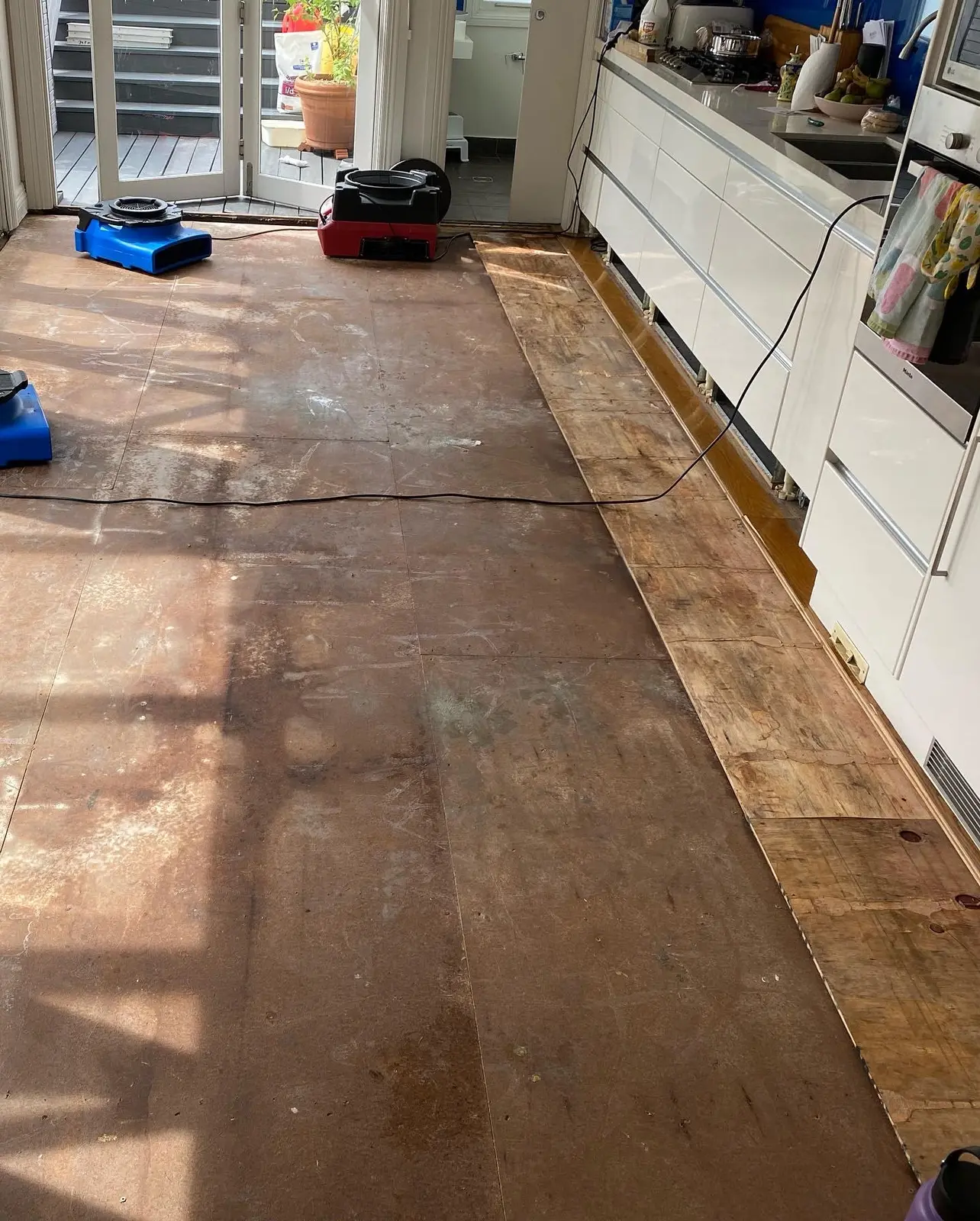 Drying equipment along an affected kitchen floor
