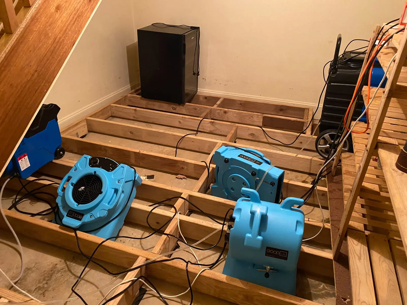 Air movers beneath stairs